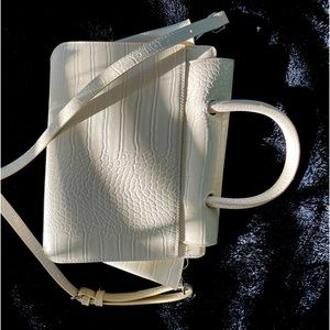 Cream colored patterned faux leather handbag